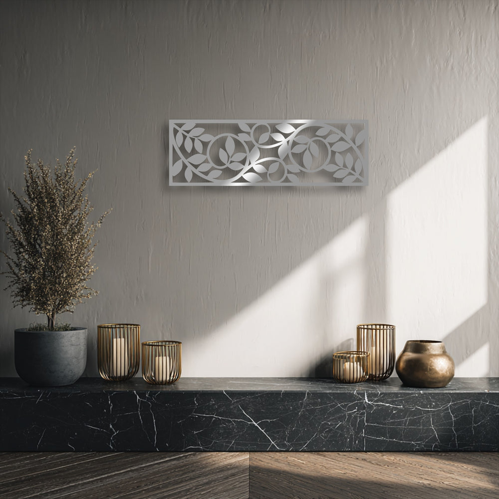 A dimensional layering effect is evident with the botanical vine metal wall decor, casting intricate shadows on the textured wall.