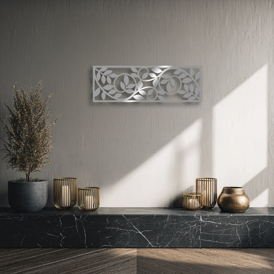 A dimensional layering effect is evident with the botanical vine metal wall decor, casting intricate shadows on the textured wall.