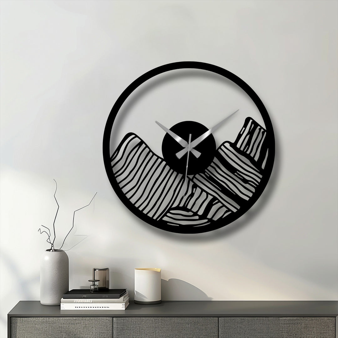 Circular edge frames a modern canyon landscape decorative metal art clock, highlighting the border's silhouette against the wall.