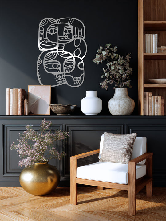 Light and shadow enhance the modern cubist metal artwork, showcasing the abstract faces connection as a striking example of metal artwork.