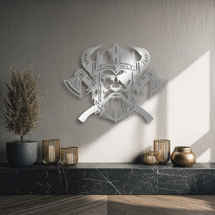 The intricate, sharp edges and precise borders of the decorative metal art vividly outline the fierce Viking warrior's helmet and axes.
