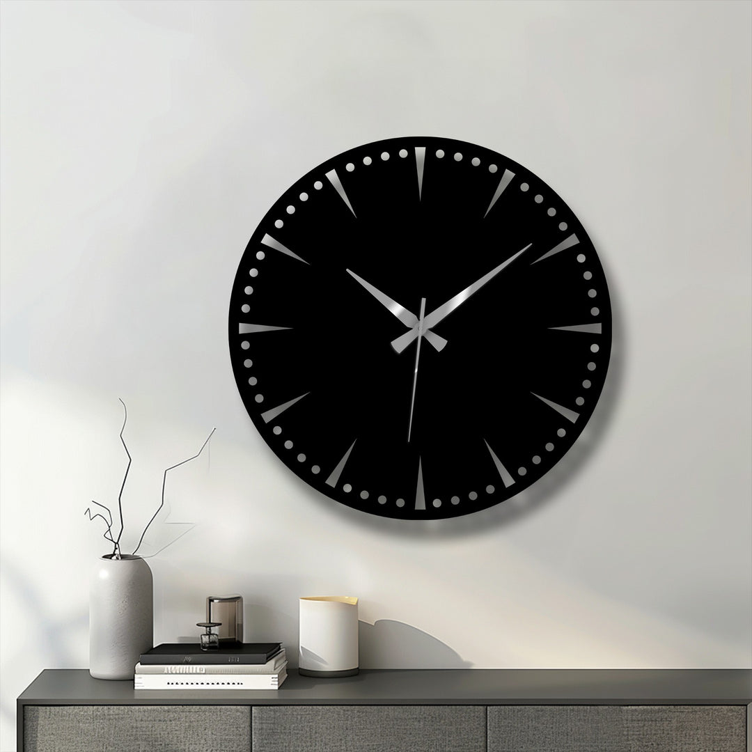 Horizontally-oriented round luxury black metal wall clock showcases a minimalist dial with silver hands, a striking piece of metal wall decor.