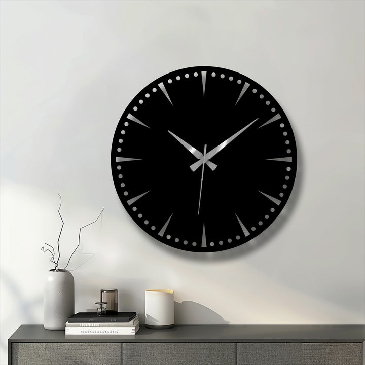 Horizontally-oriented round luxury black metal wall clock showcases a minimalist dial with silver hands, a striking piece of metal wall decor.