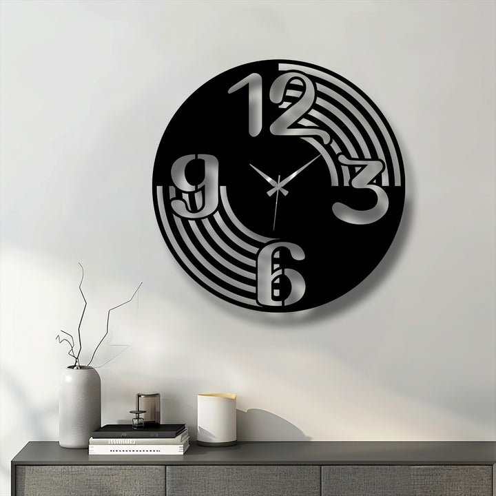 The layered design of this black metal art for wall clock creates depth with its silver numbers and flowing, concentric cut-out lines.