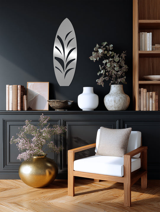 Cool color temperature highlights the black surfboard decorative metal art, casting subtle shadows that accentuate the tropical leaf design.