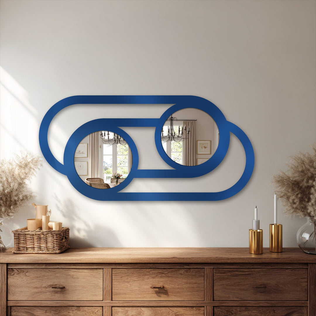 Subtle shadows add depth to the neutral background, highlighting the minimalist, linked-circle design of the blue metal artwork decorative mirror.