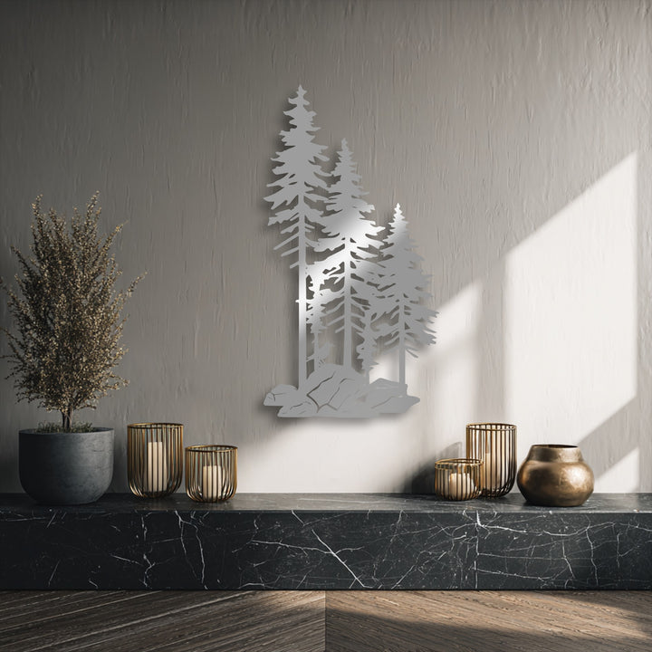 Gold-caged candles, a potted plant, and a bronze vase rest on a dark marble foreground, enhancing the forest pine trees metal art for wall.