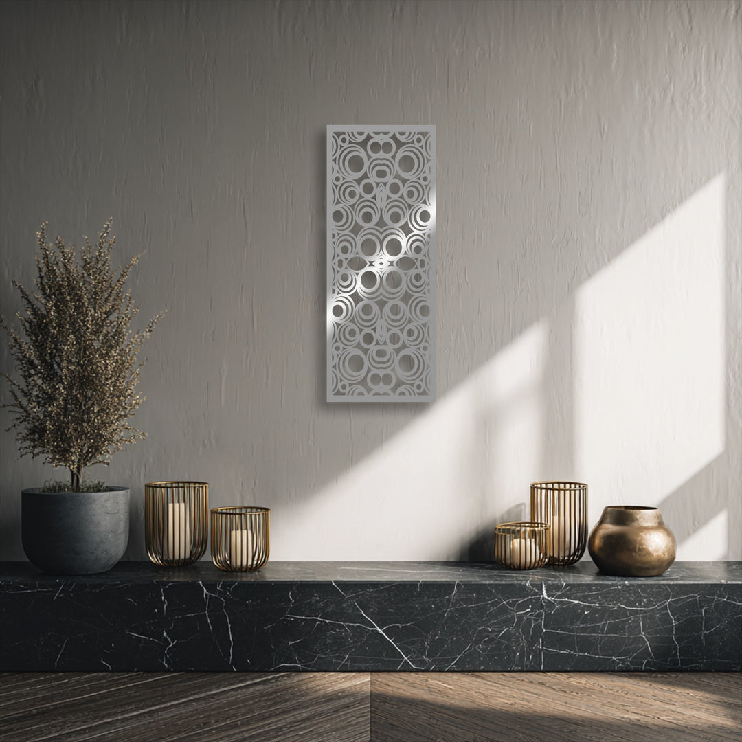 Striking color contrast between the light geometric circle decorative metal art and dark black marble base creates a focal point.