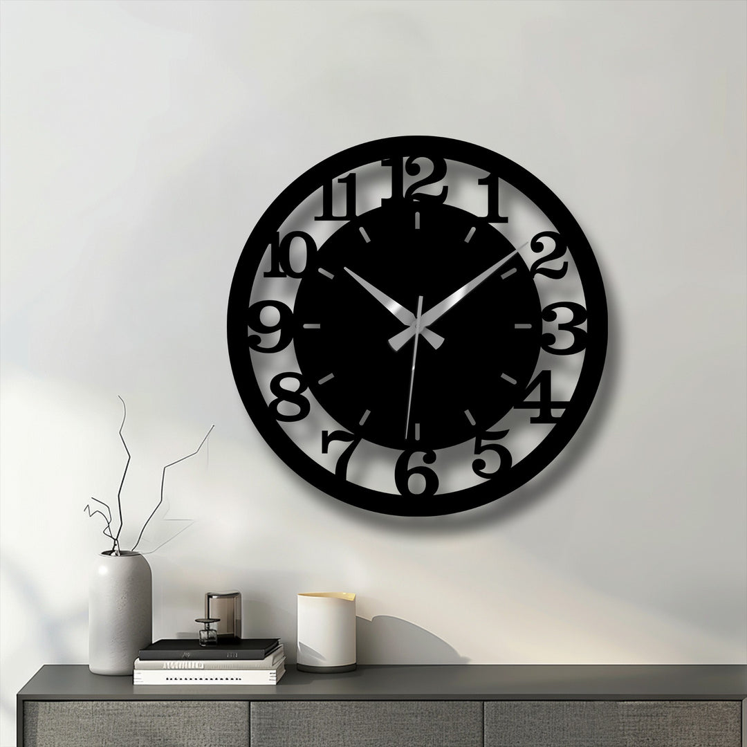 Striking color contrast defines this modern black numbered metal wall clock, an eye-catching piece of home decor.