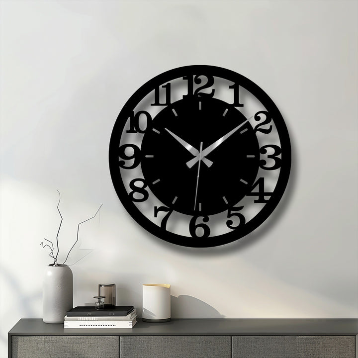 Striking color contrast defines this modern black numbered metal wall clock, an eye-catching piece of home decor.