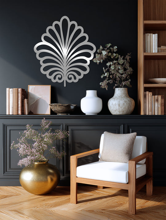 Focusing on the geometric elements, this botanical leaf unique metal wall art features symmetrical, stylized fronds and spiraled details in a silver-toned metallic finish.