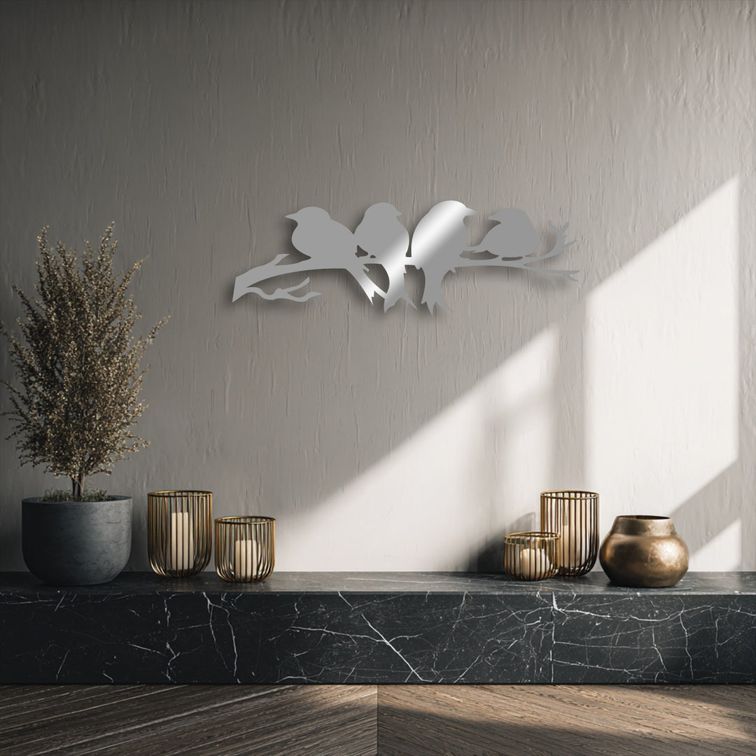 The rhythm created by the flowing lines of the birds on branch metal artwork enhances the textured wall, reflecting light beautifully.
