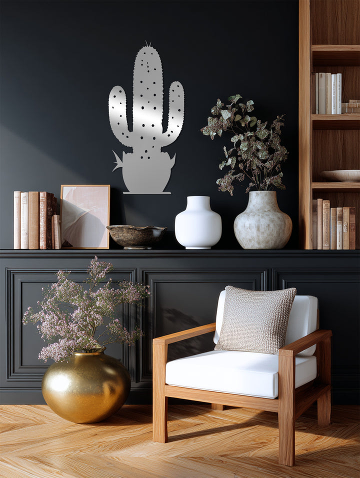 The darkest area highlights a contemporary unique metal wall art piece depicting a cactus, casting shadows and adding depth to the modern decor above the shelf.
