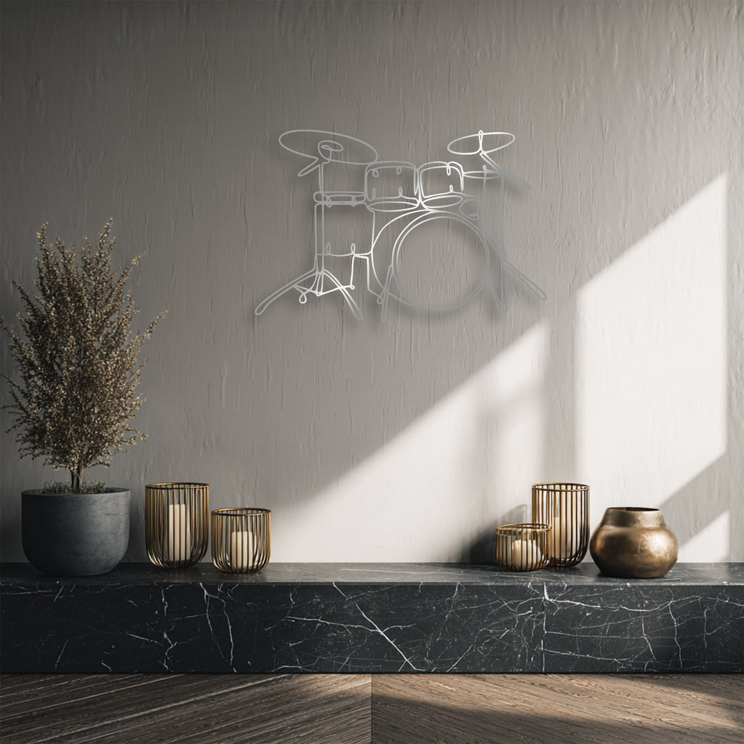 Sharp color contrast defines the minimalist drum set line art metal wall decor against a textured gray wall, with a stark diagonal sunbeam.