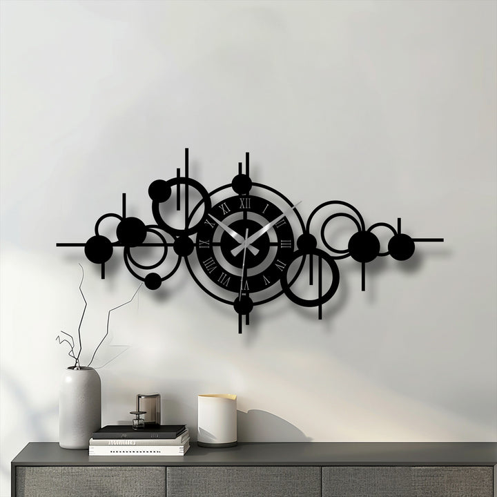 Black dominates this abstract circle orbit metal wall clock, a piece of decorative metal art displaying a modern geometric design.