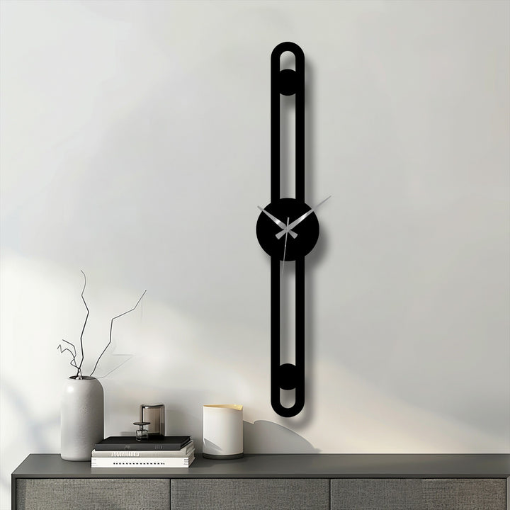 Reduced color saturation highlights the black minimalist vertical metal wall clock, a unique metal wall art piece with a modern, slim line design.