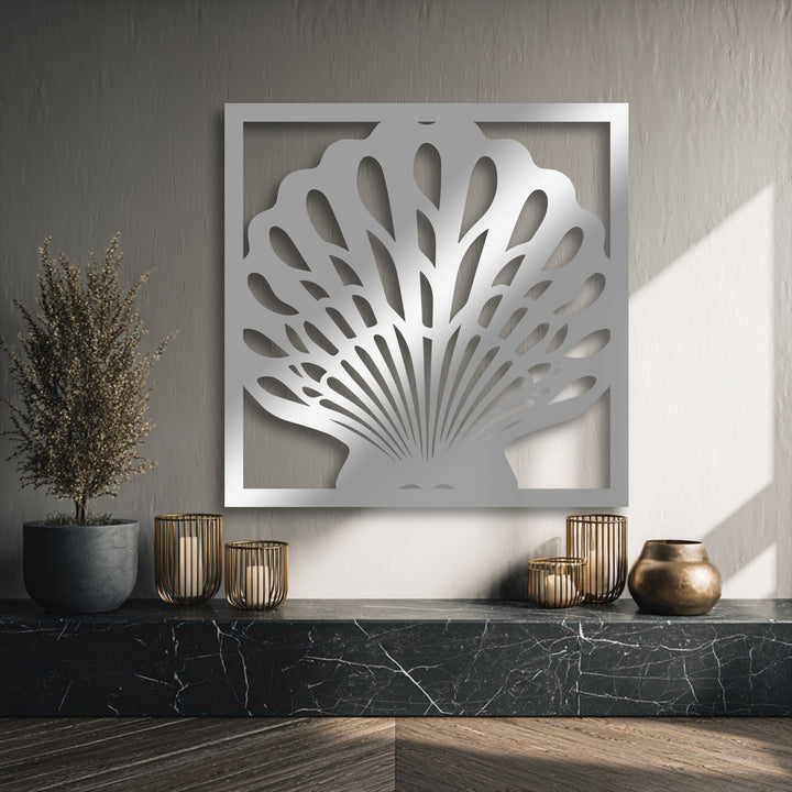 The high-quality silver metal artwork featuring an elegant seashell design within a sleek frame showcases superior craftsmanship and durability.