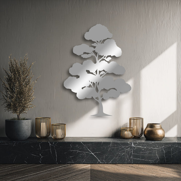 Strong light and shadow play across a textured wall, highlighting a reflective Zen Bonsai Tree metal artwork and nearby decor.