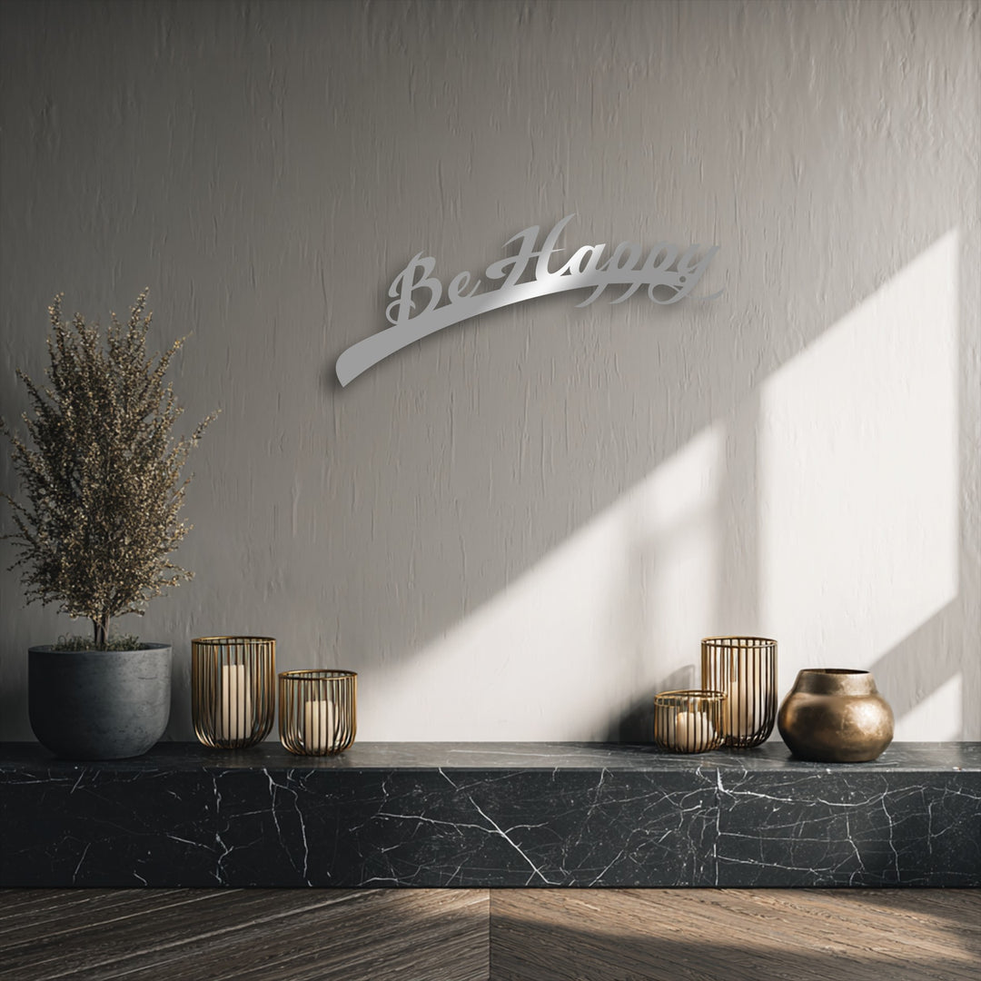 Be Happy Script decorative metal art creates striking depth and layers with its form and prominent shadow on a textured wall.