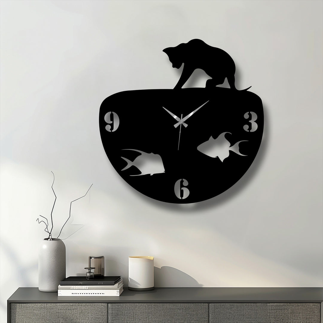 The negative space in this metal art for wall clock highlights the sleek black cat silhouette and the fish swimming within the bowl, a modern design.