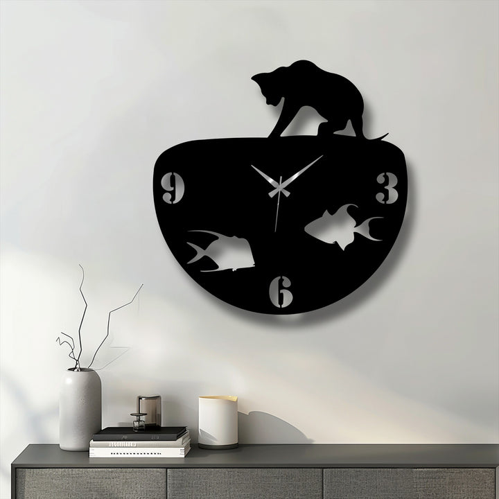 The negative space in this metal art for wall clock highlights the sleek black cat silhouette and the fish swimming within the bowl, a modern design.