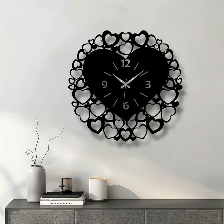 Featuring a striking jet black, this romantic heart frame decorative metal art wall clock showcases an intricate love-inspired design.
