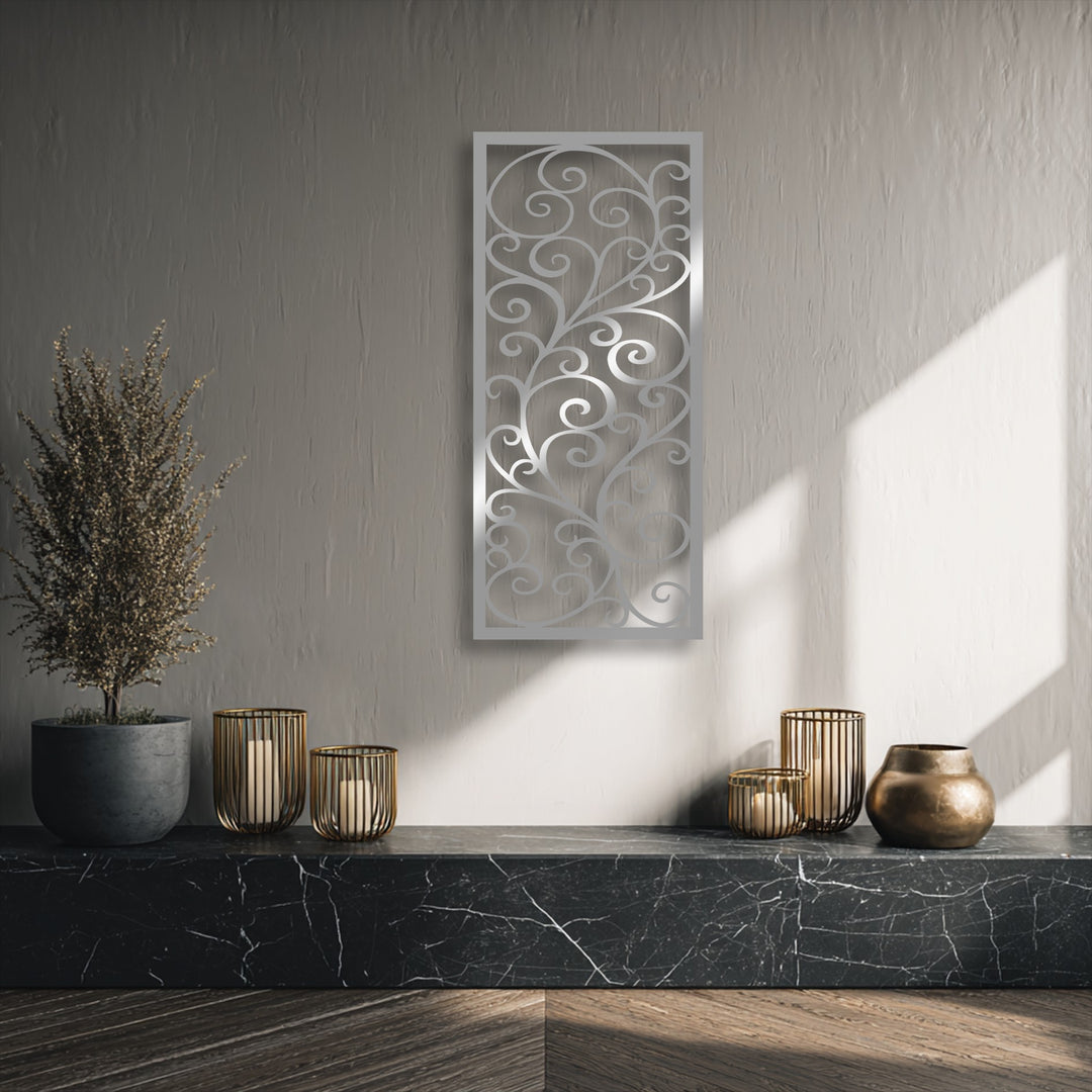 The elegant scroll pattern of the rectangular metal artwork showcases intricate swirling geometric elements against a textured wall.