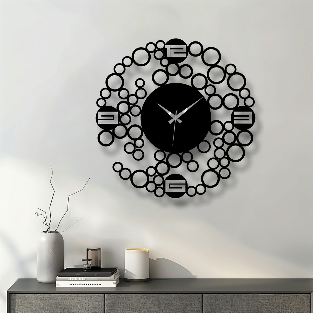 Seen as the focal point, this modern bubble ring metal wall clock features a minimalist geometric design creating a striking and unique metal wall art piece.