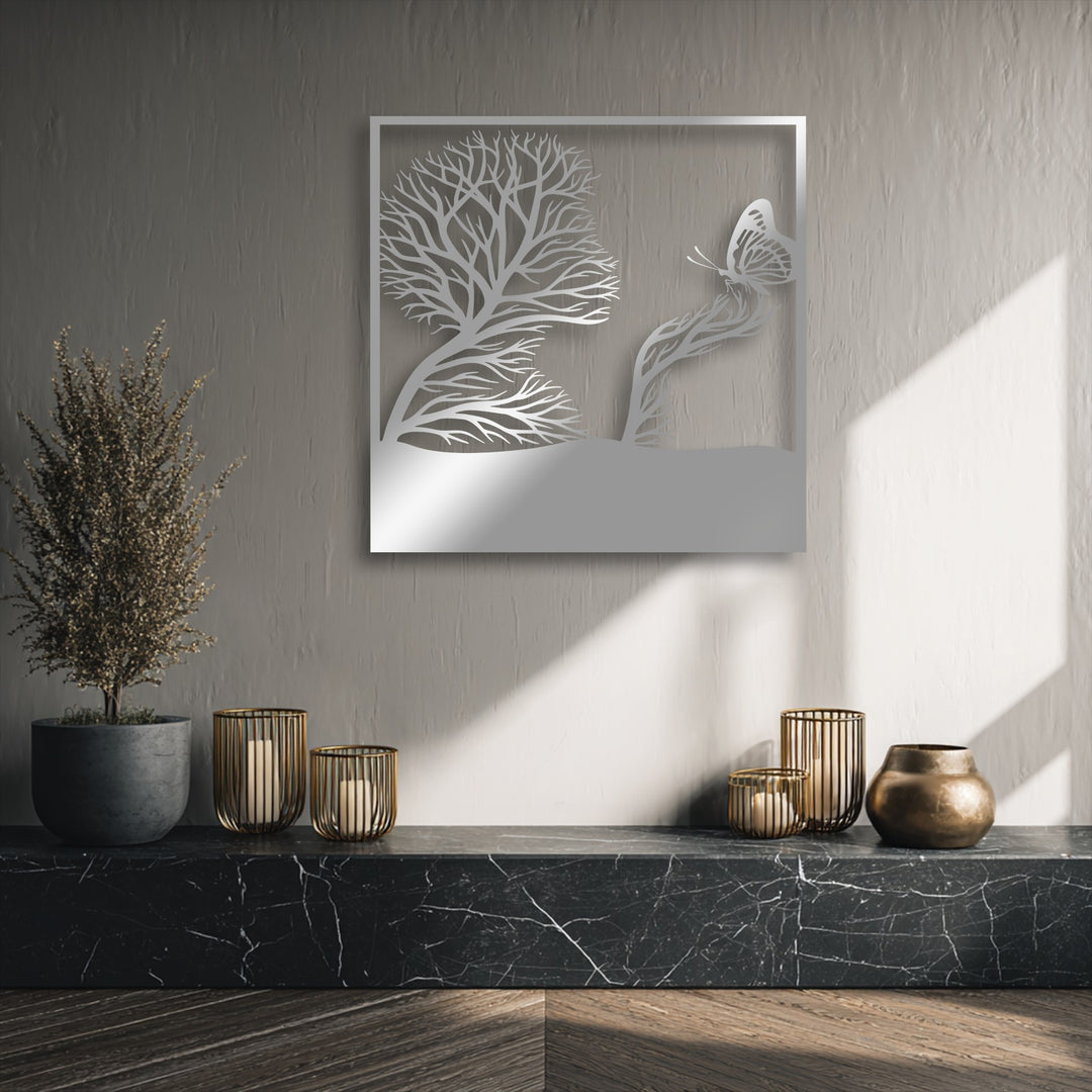 The brightest area showcases natural light illuminating the lower section of a whimsical tree and butterfly artistic nature decorative metal art piece.