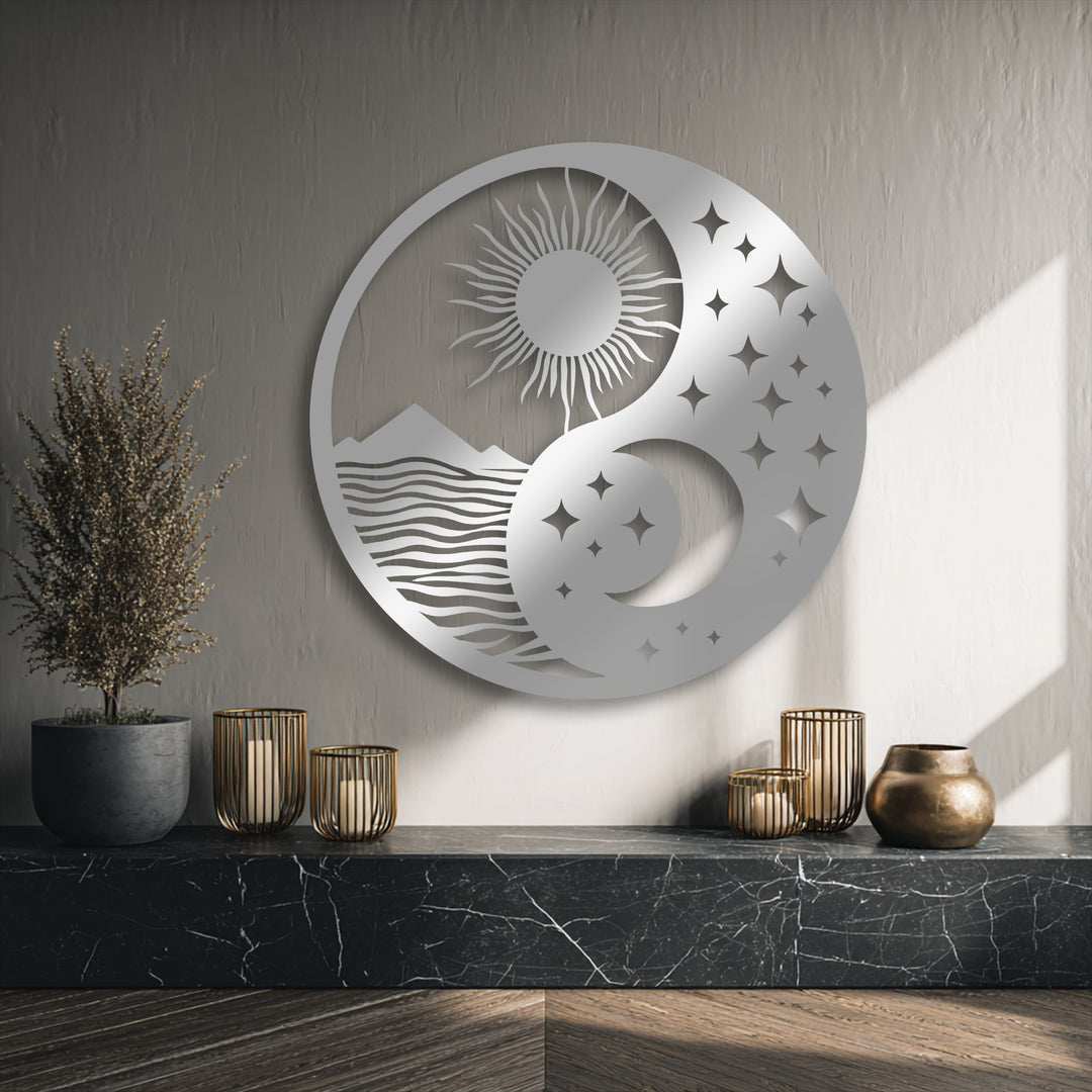 The matte silver finish of this decorative metal art showcases a celestial balance yin yang design with sun, moon, and landscape.