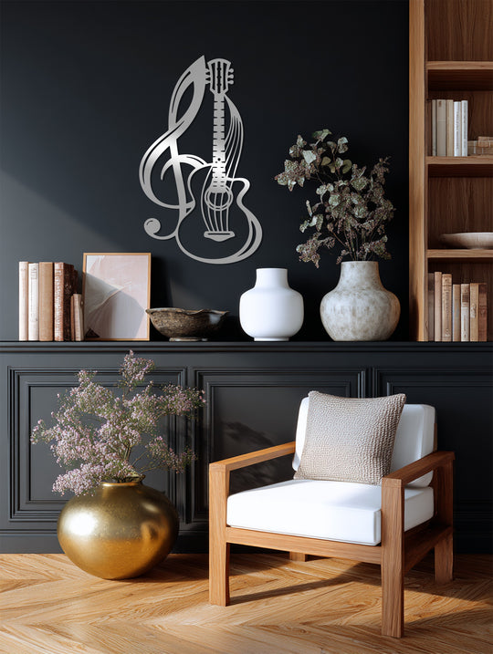 Subdued color saturation highlights the sleek, silver Harmony Strings unique metal wall art featuring a guitar and musical note design, displayed against a dark wall.