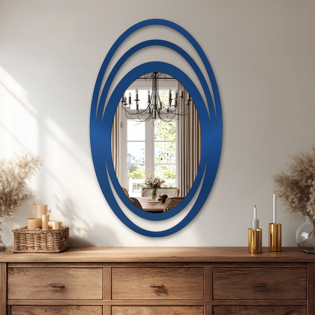 Reflected in the Triple Halo Oval Wall Mirror's glass is a dining room setting with a black chandelier, enhancing ideas for decorating with wall mirrors by adding depth.