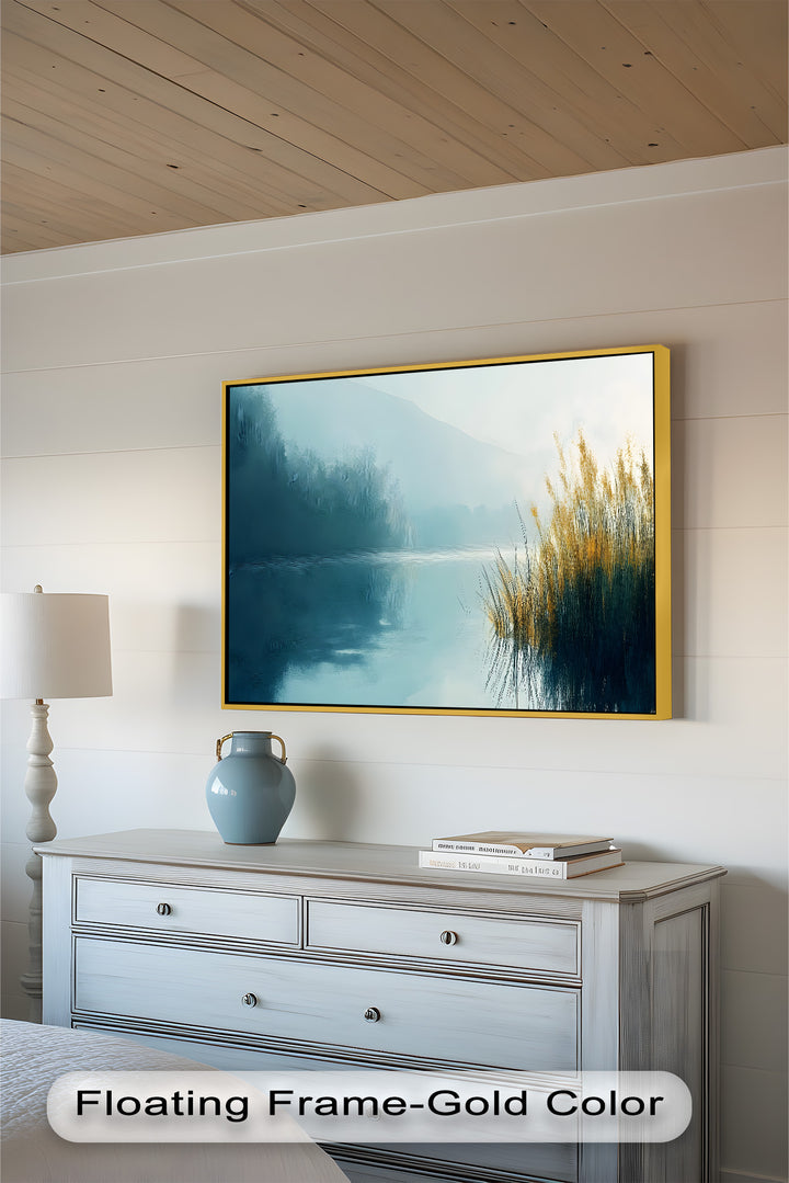 A dreamy waterscape unfolds in this elegant composition, where soft mist veils the distant shoreline, and sunlit reeds contrast beautifully against the cool, reflective lake.