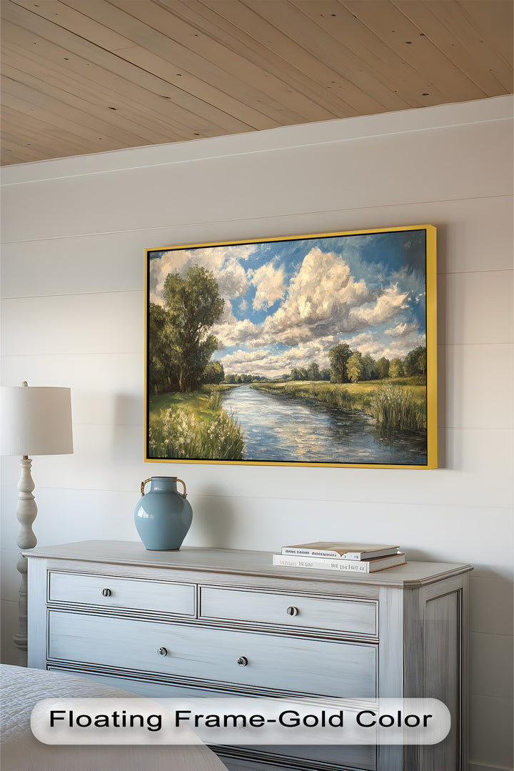 Pastoral scene with meandering river under bright blue sky and clouds.
