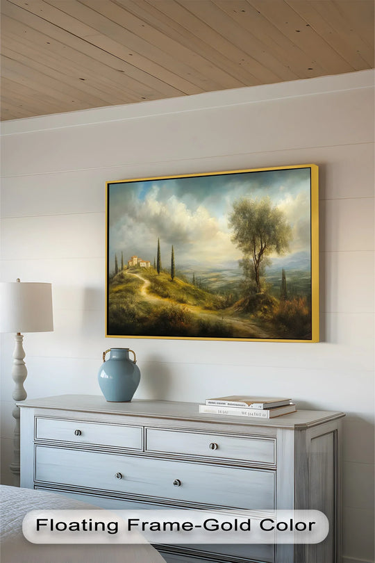 A sunlit Mediterranean landscape with a lone tree in the foreground and rolling hills stretching into the distance.