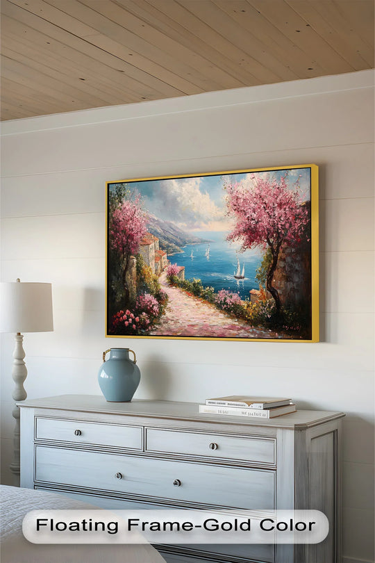 Rich surface texture accentuates the brushstrokes of this impressionistic oil painting art piece, depicting a charming coastal street with spring blossoms.