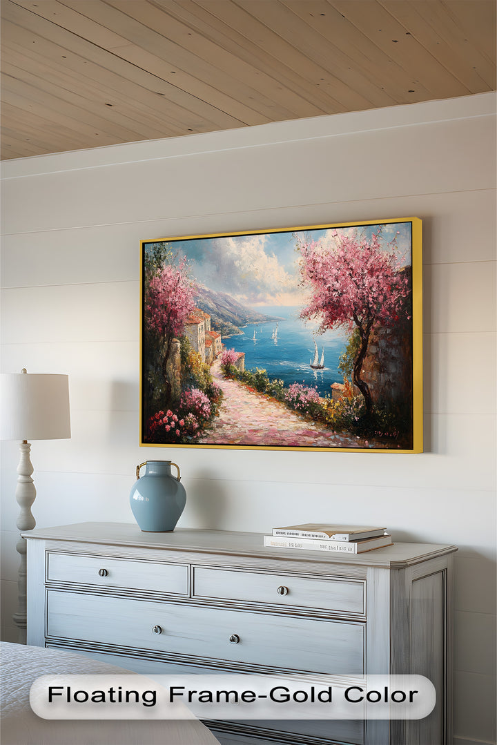 This stunning impressionist-style artwork captures the charm of a seaside village, with lush floral trees and rustic architecture overlooking the sparkling turquoise waters.