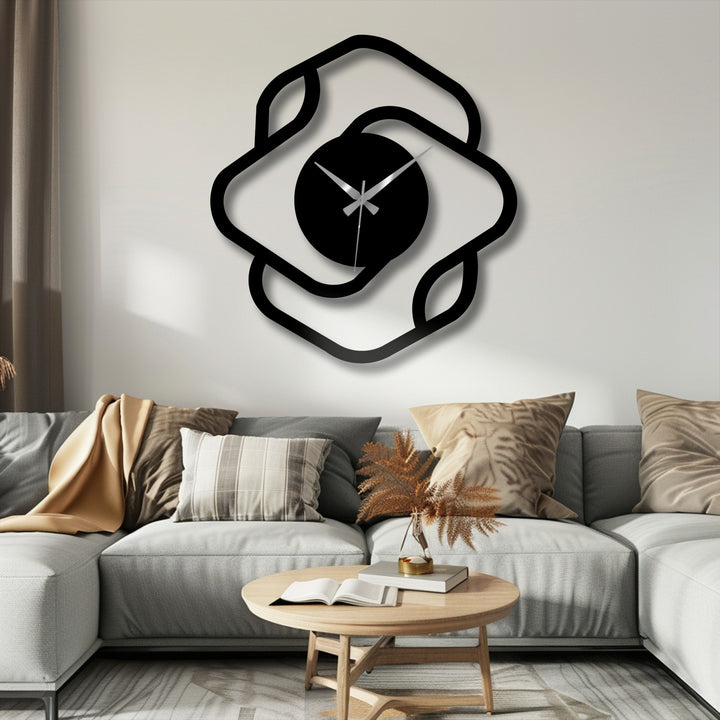 Visual rhythm is created by the repeating rounded square shapes that surround the round clock face of this modern abstract metal wall decor.