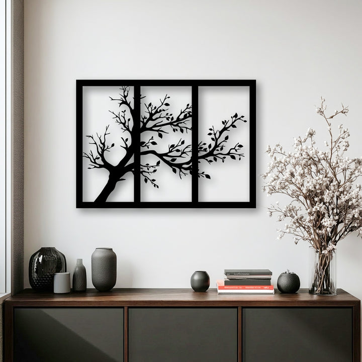 The striking layering effect of the minimalist tree silhouette within a three-panel decorative metal art triptych.