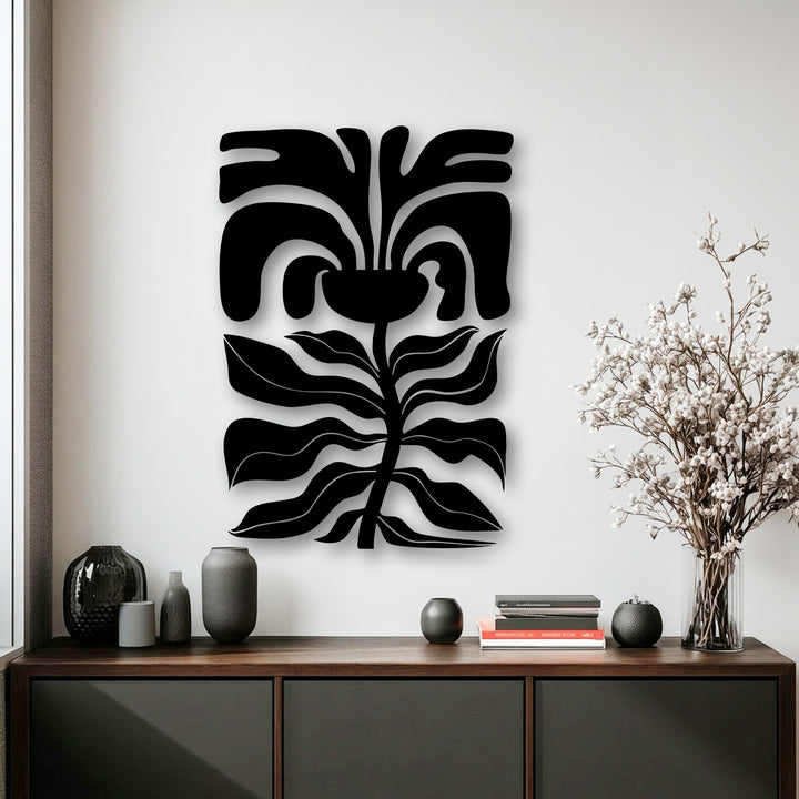 The crisp, well-defined edges and borders of the abstract floral face metal decoration wall art create a modern botanical line decor.