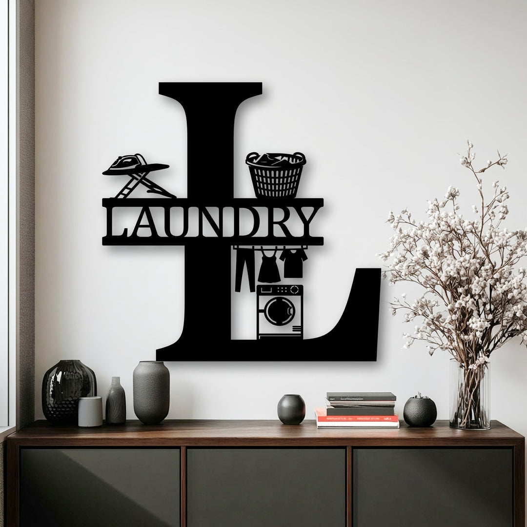 The focal point is the custom initial metal wall art, a sophisticated black L-shaped decoration featuring detailed laundry elements.