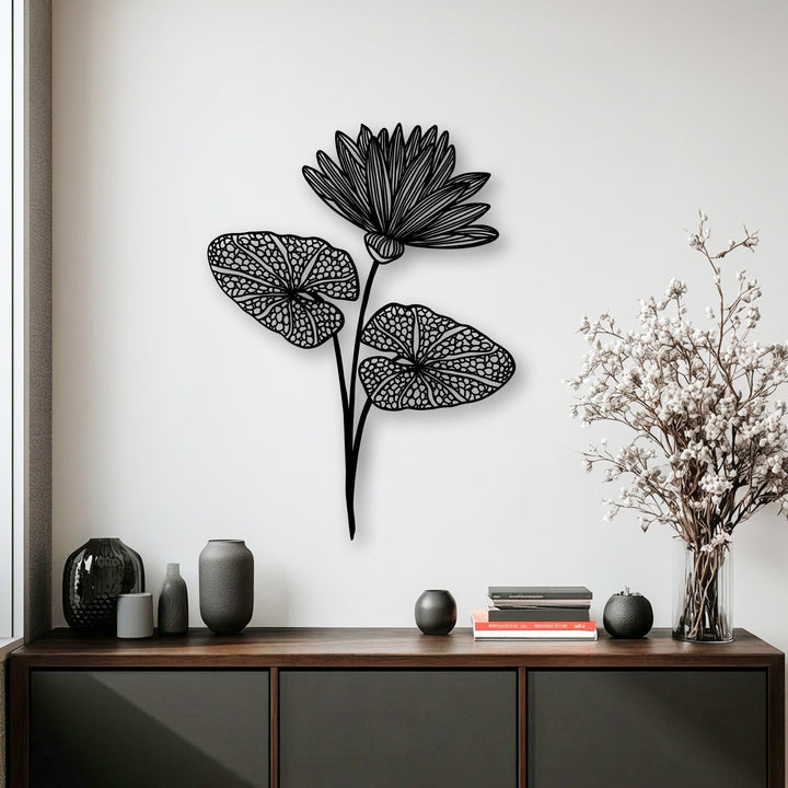 Bright white background highlights the elegant black lotus decorative metal art above a dark wood console table.