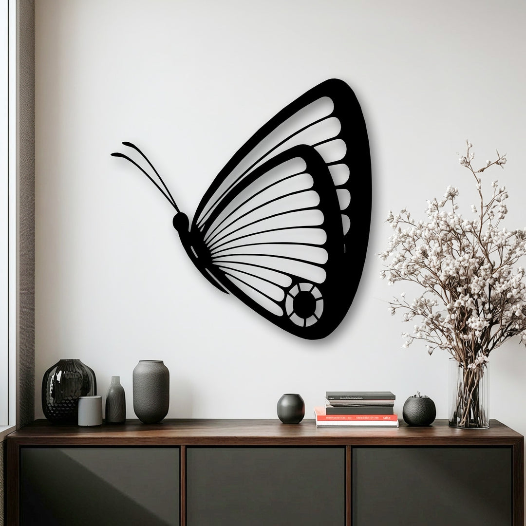 The pristine white wall serves as a brilliant backdrop for an elegant butterfly metal wall art, a stunning decoration wall art piece.