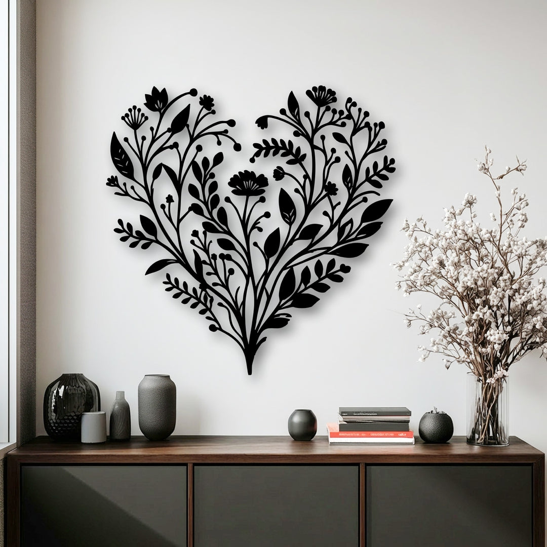 Soft, delicate white dried flowers in a clear vase complement the intricate botanical heart metal art for wall.