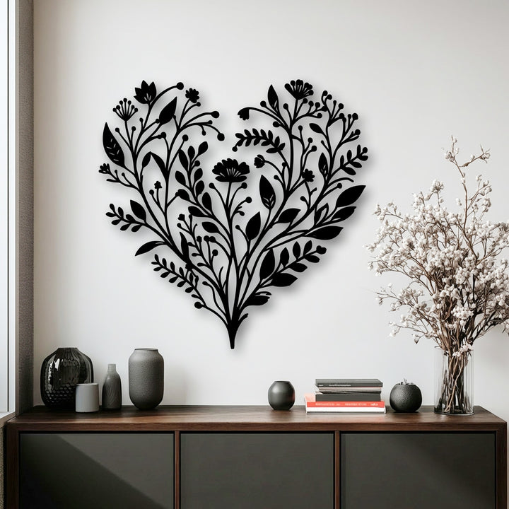 Soft, delicate white dried flowers in a clear vase complement the intricate botanical heart metal art for wall.