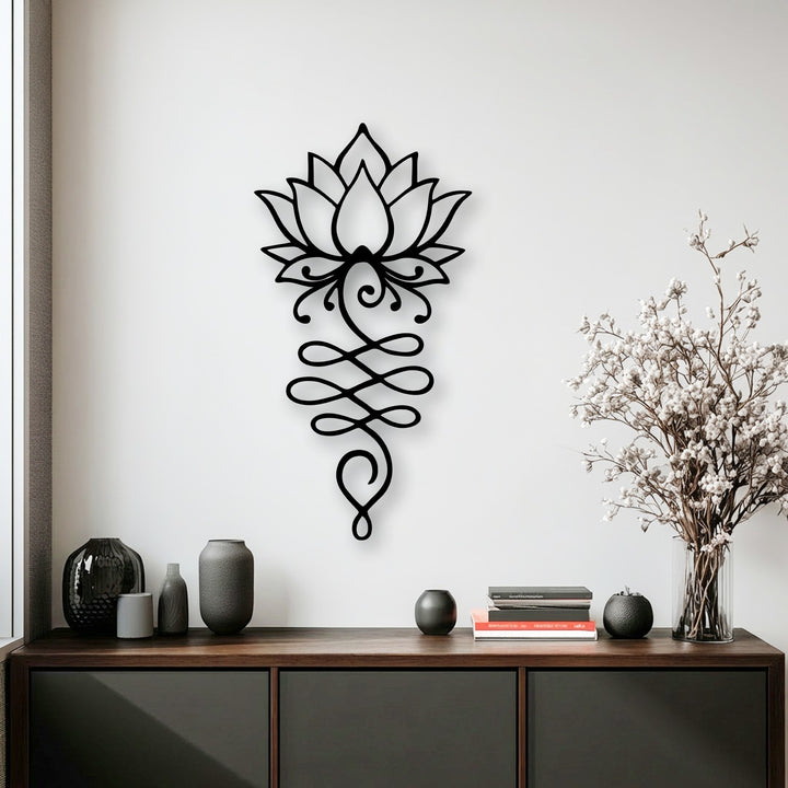 The crisp transition from the bright white wall to the intricate black lotus flower symbol metal artwork gracefully descends to the rich, dark tones of the console.