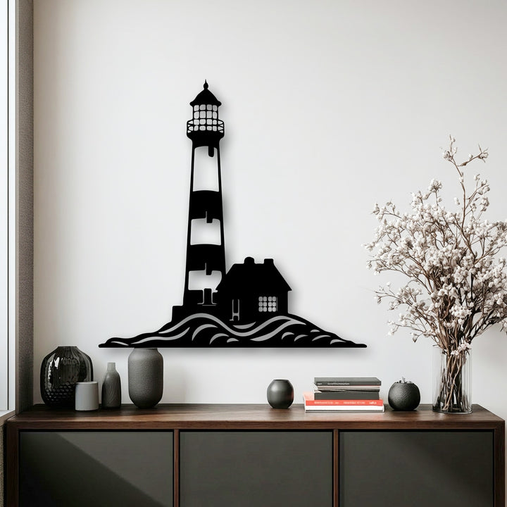 A horizontally aligned decorative metal art piece showcases a distinct silhouette shape of a coastal lighthouse and house on rolling waves.