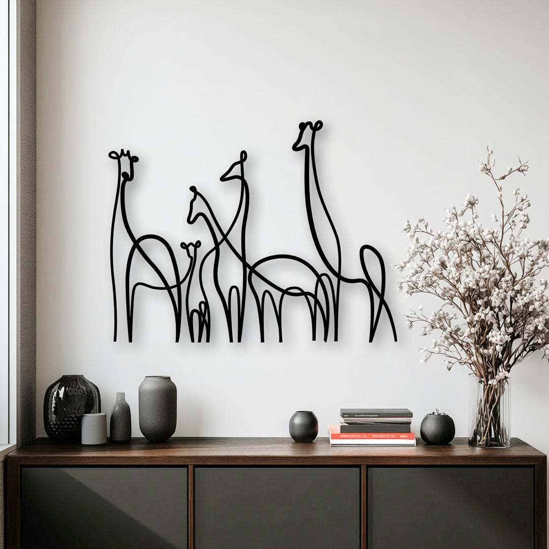 This horizontally oriented metal artwork showcases the elegant curved and flowing shapes of a minimalist giraffe family line art.
