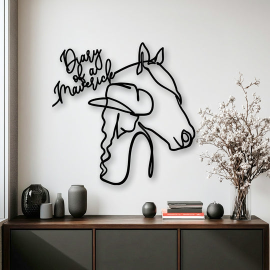The sharp, distinct borders of the 'Diary of Maverick' unique metal wall art showcase the minimalist cowgirl and horse design.
