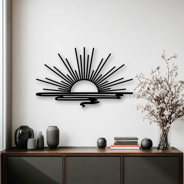 Bright white wall displaying sleek black minimalist sunrise metal wall art with radiant beams over calm water, perfect for modern decoration wall art.